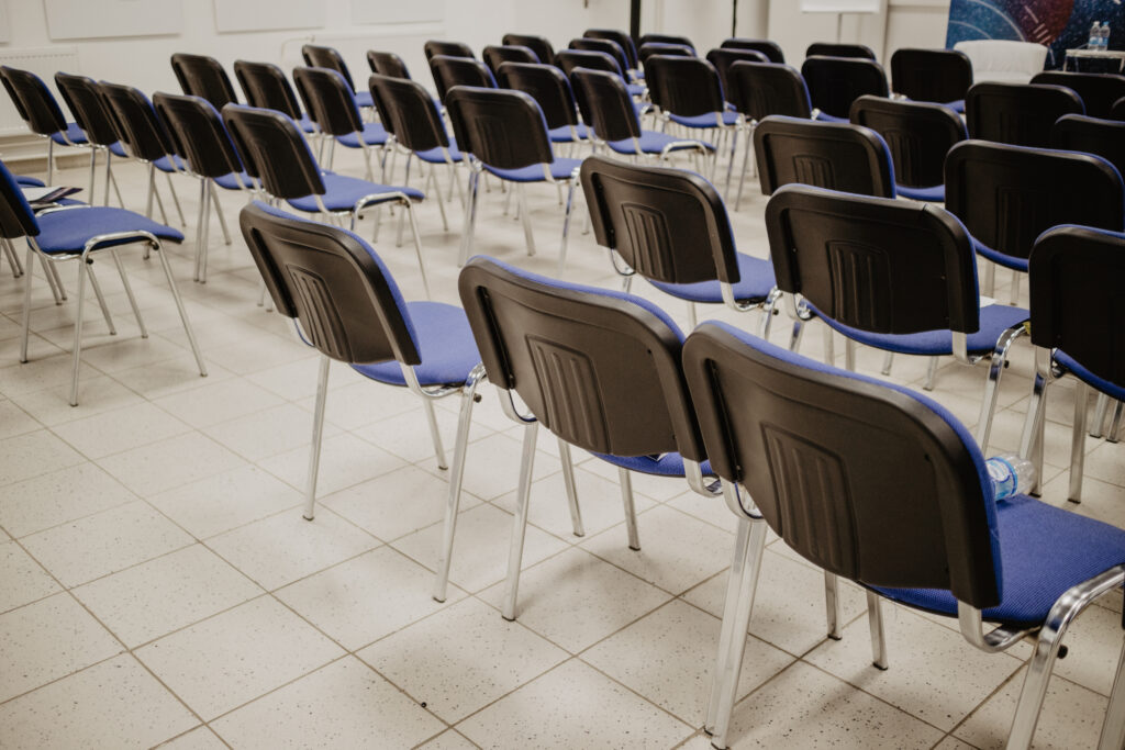 Rows of empty chairs set out in a training room before a staff training session